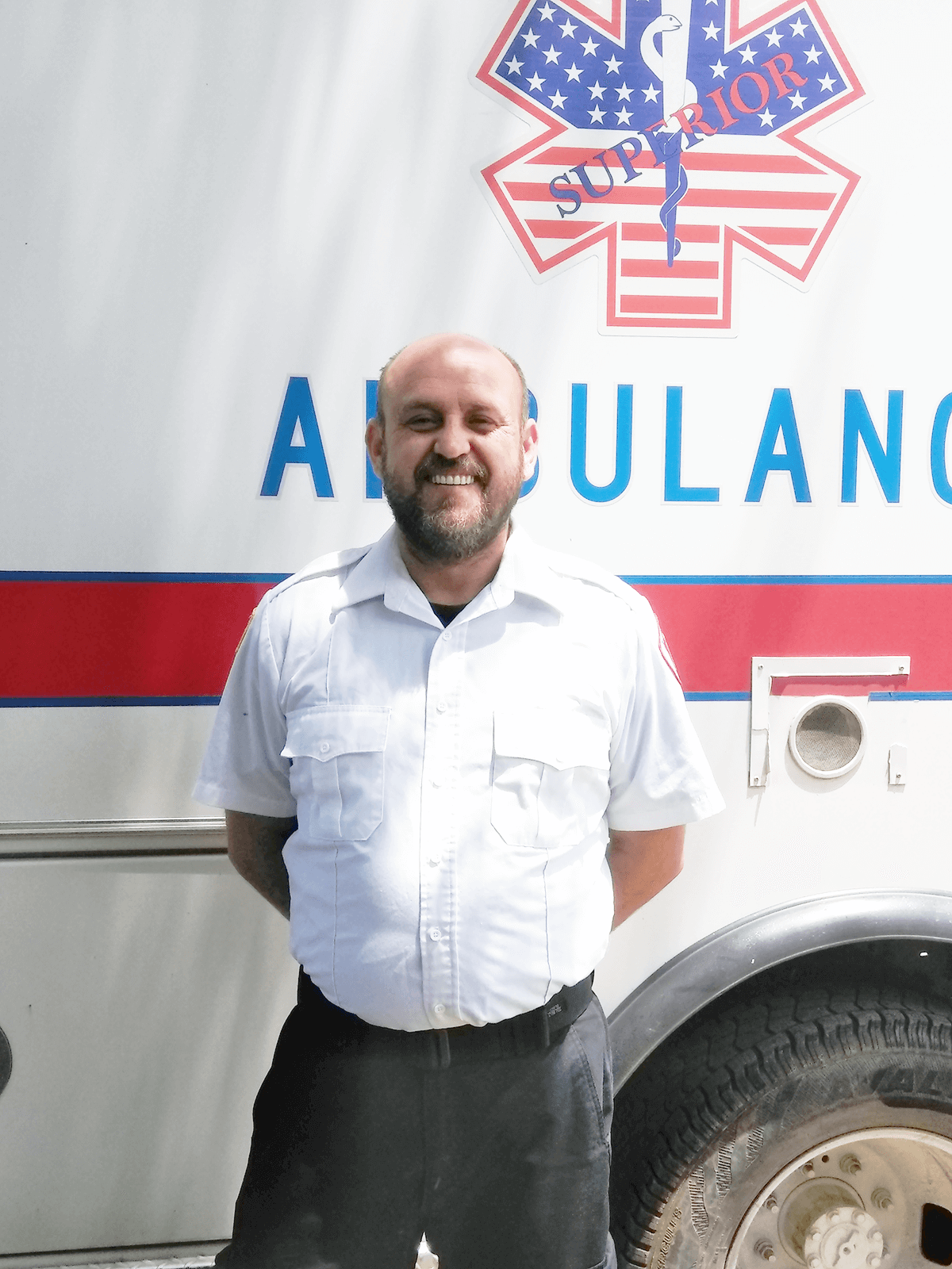 James Certain pictured standing in front of an ambulance